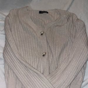 Cropped, cream colored, cardigan.